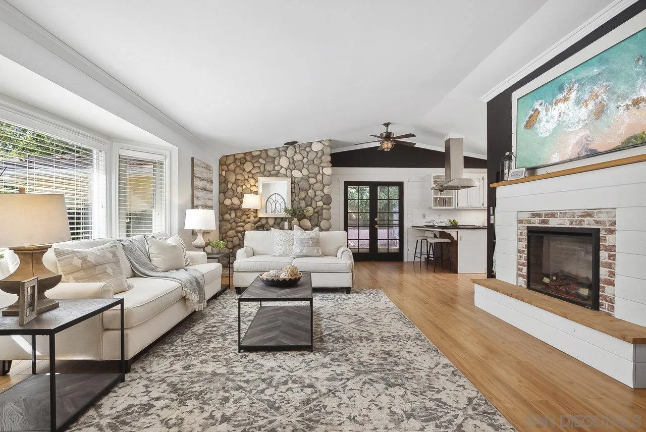 1369 Friends Way Fallbrook, CA 92028 - Photo 2 of 29 a living room with furniture a fireplace and a large window