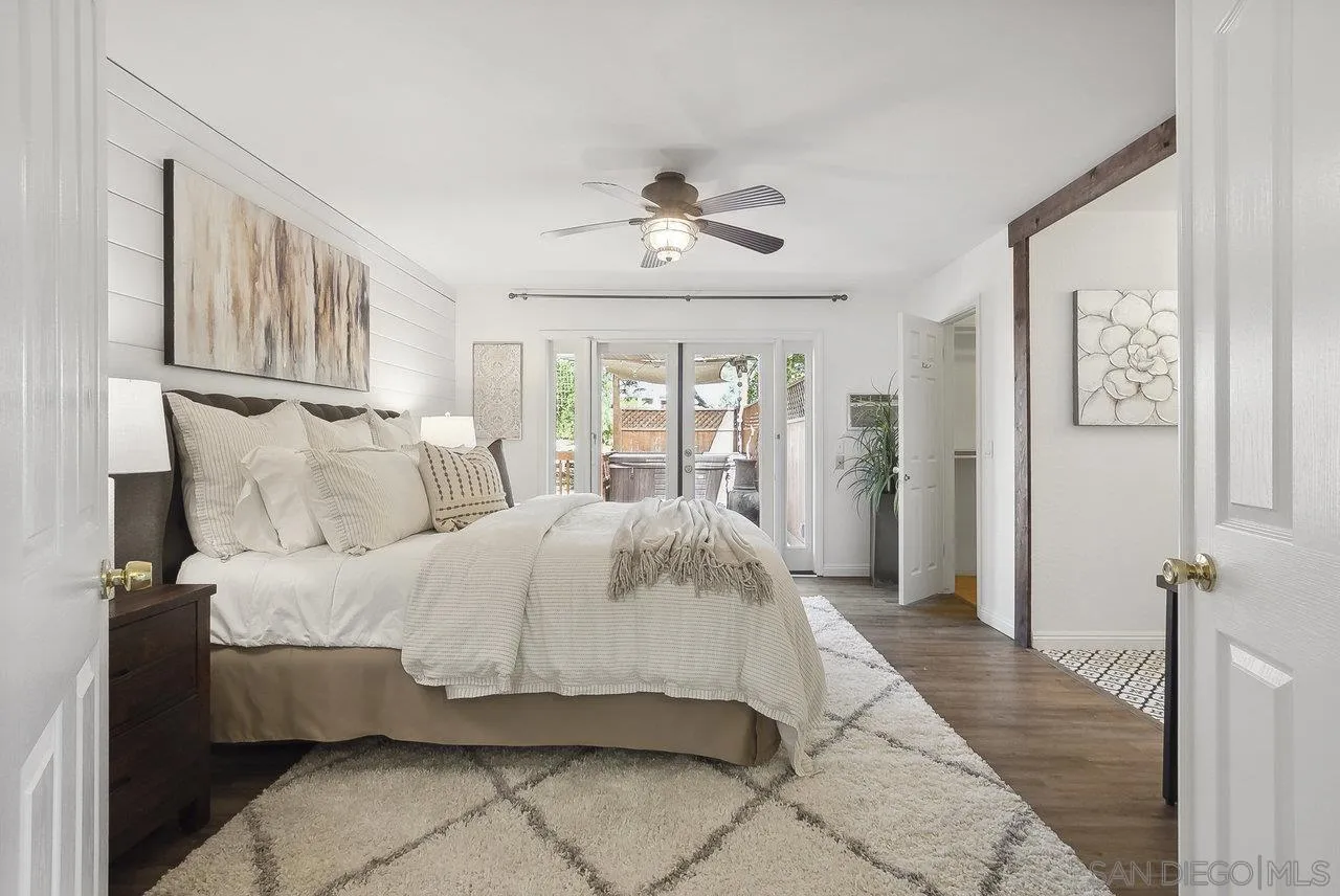 1369 Friends Way Fallbrook, CA 92028 - Photo 4 of 29 a spacious bedroom with a bed and glass windows