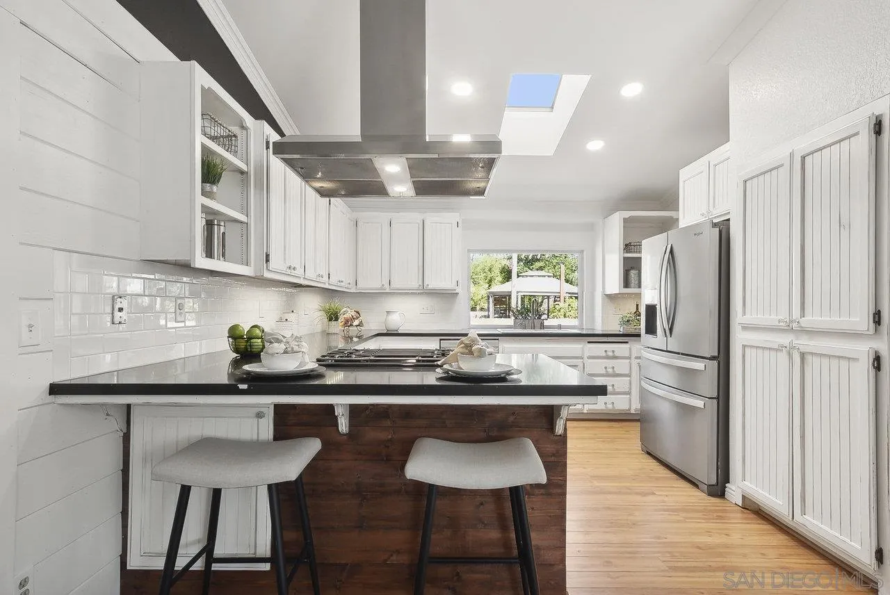 1369 Friends Way Fallbrook, CA 92028 - Photo 6 of 29 a kitchen with stainless steel appliances granite countertop a sink a stove a refrigerator and wooden cabinets