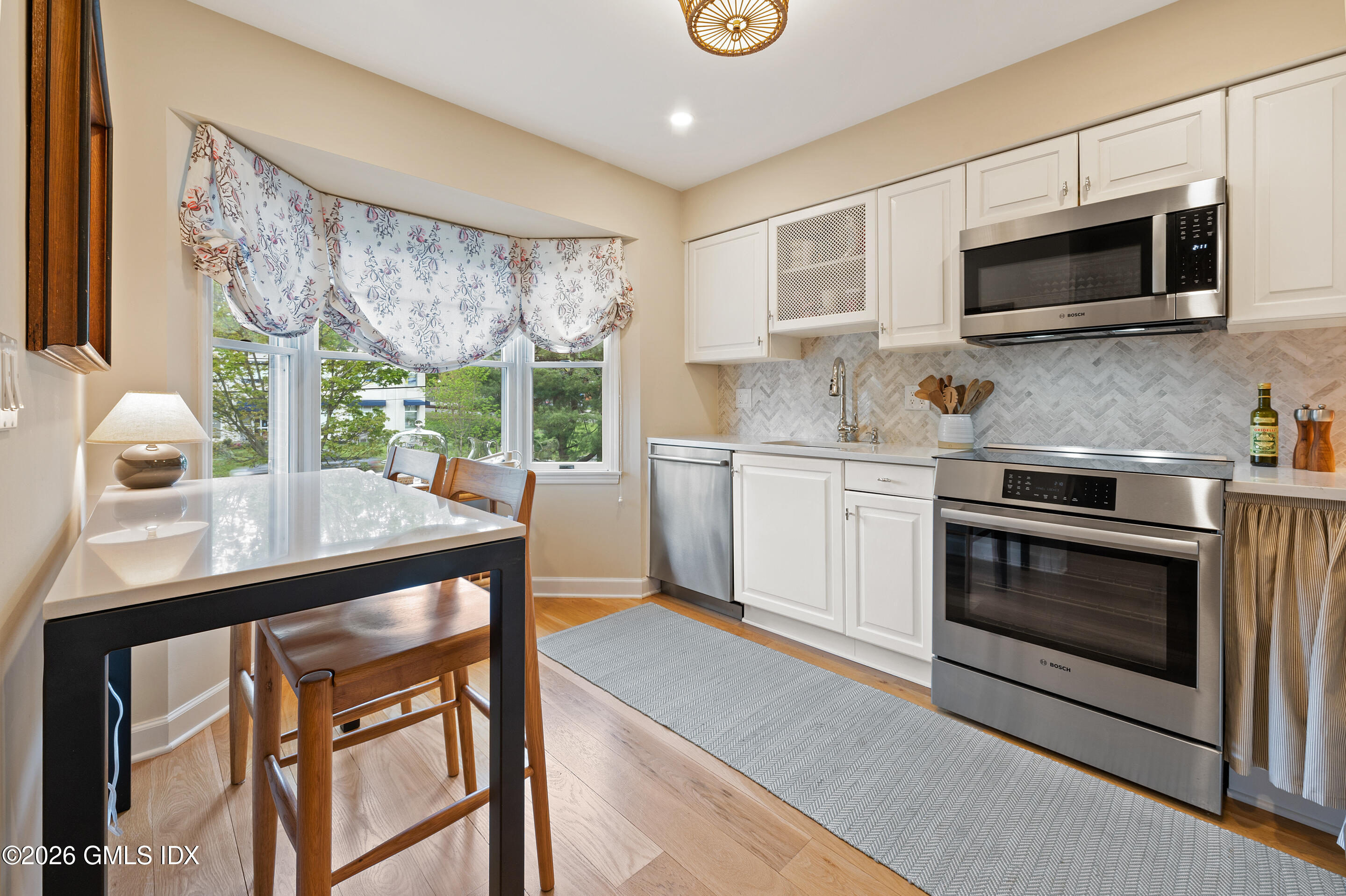 115 River Road, Unit 3 Cos Cob, CT 06807 - Photo 11 of 40 a kitchen with stainless steel appliances a stove a sink and a microwave