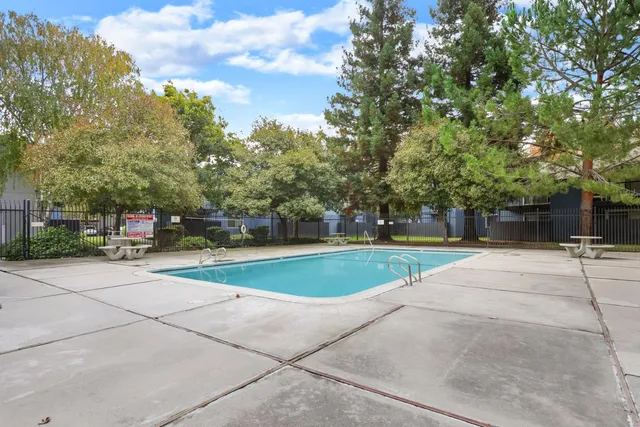 a view of backyard with outdoor seating and trees