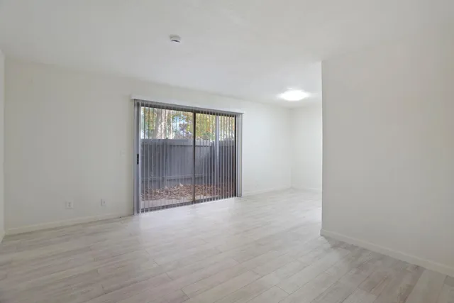 a view of a kitchen with a sink and wooden floor