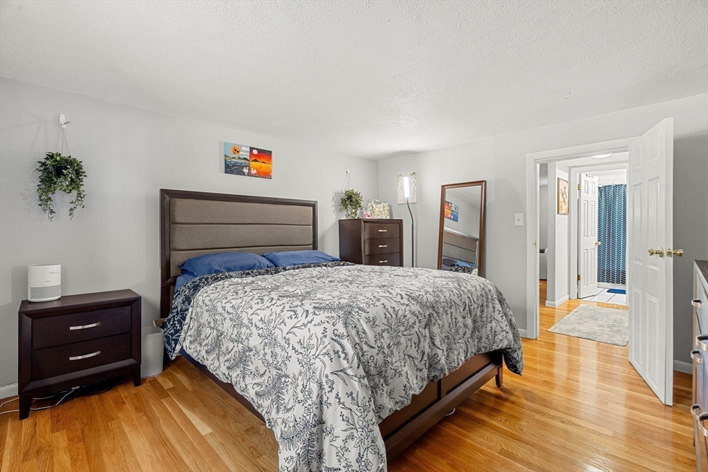 24 Westgate Road, Unit 2 Boston, MA 02467 - Photo 12 of 21 a bedroom with a bed and a dresser