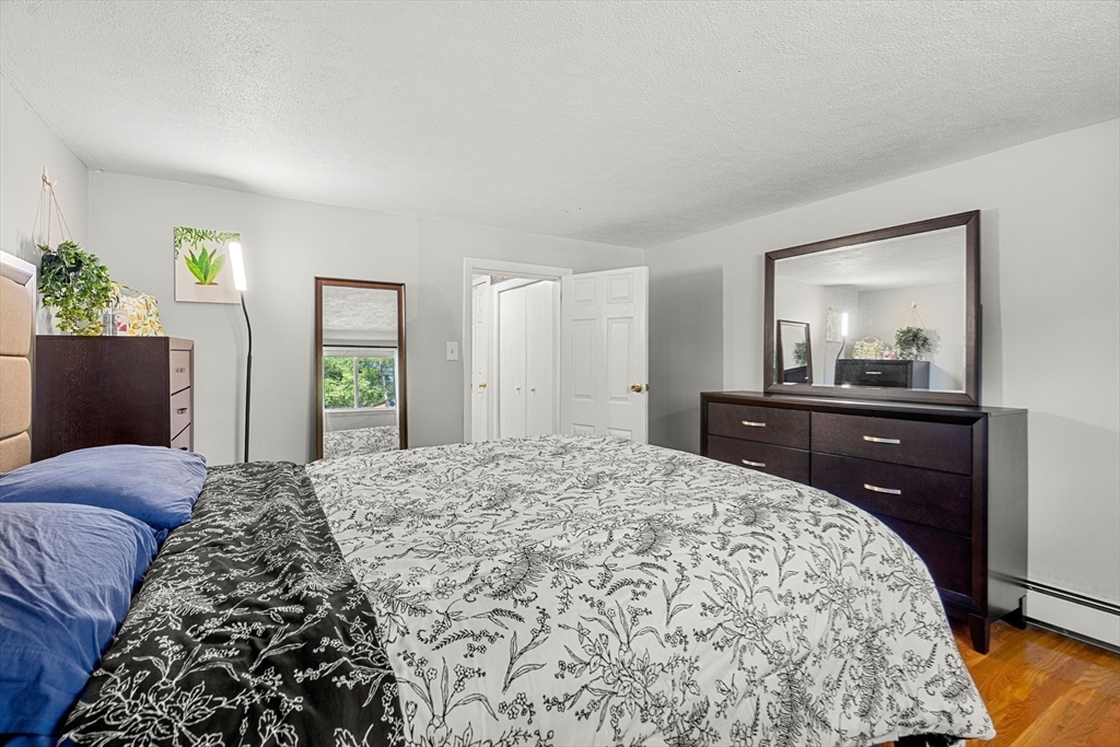 24 Westgate Road, Unit 2 Boston, MA 02467 - Photo 14 of 21 a bedroom with a bed and a dresser