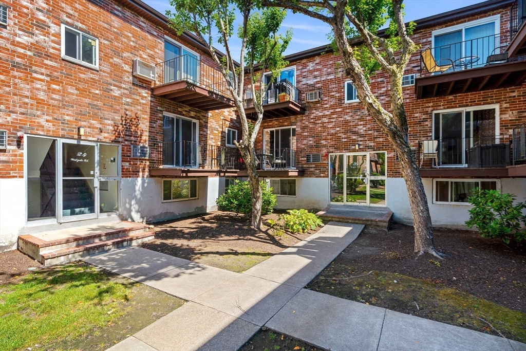 24 Westgate Road, Unit 2 Boston, MA 02467 - Photo 19 of 21 a view of a brick building with many windows