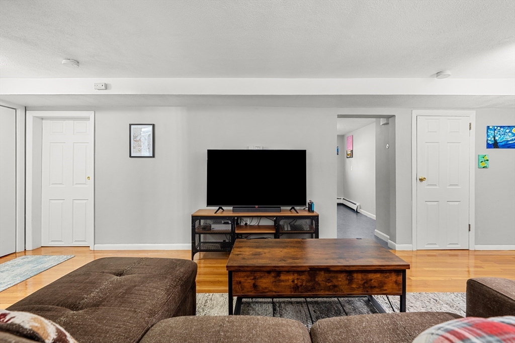 24 Westgate Road, Unit 2 Boston, MA 02467 - Photo 3 of 21 a living room with furniture and a flat screen tv