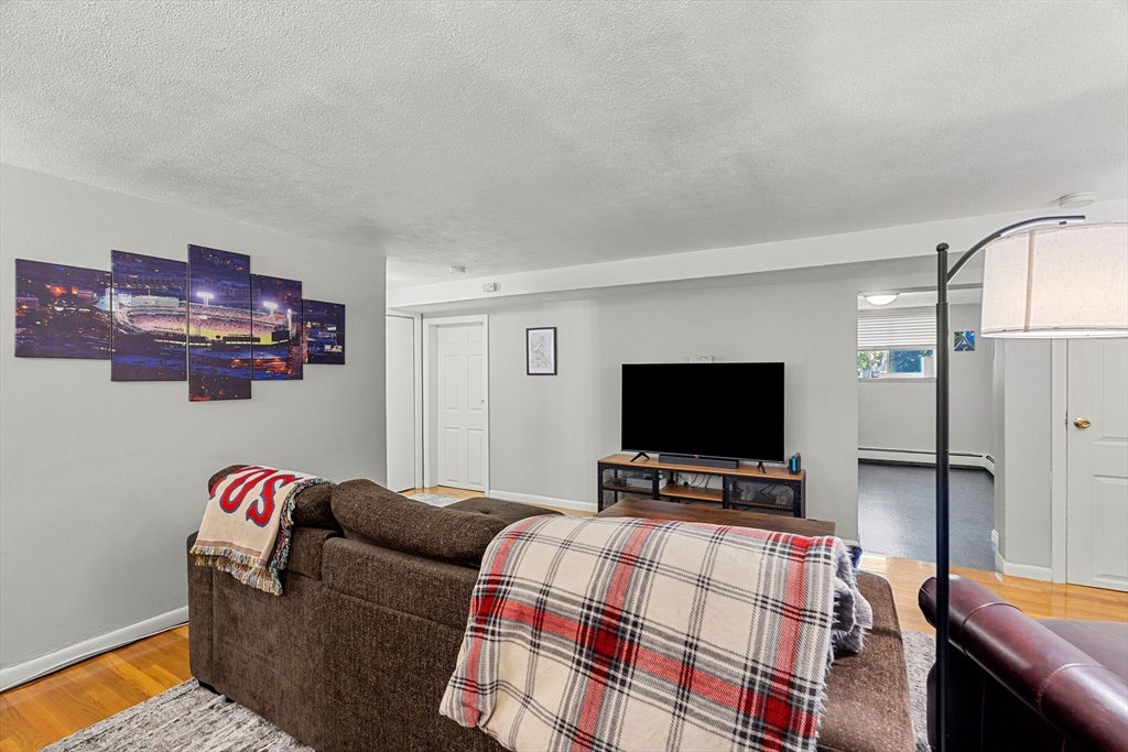 24 Westgate Road, Unit 2 Boston, MA 02467 - Photo 4 of 21 a living room with furniture and a flat screen tv