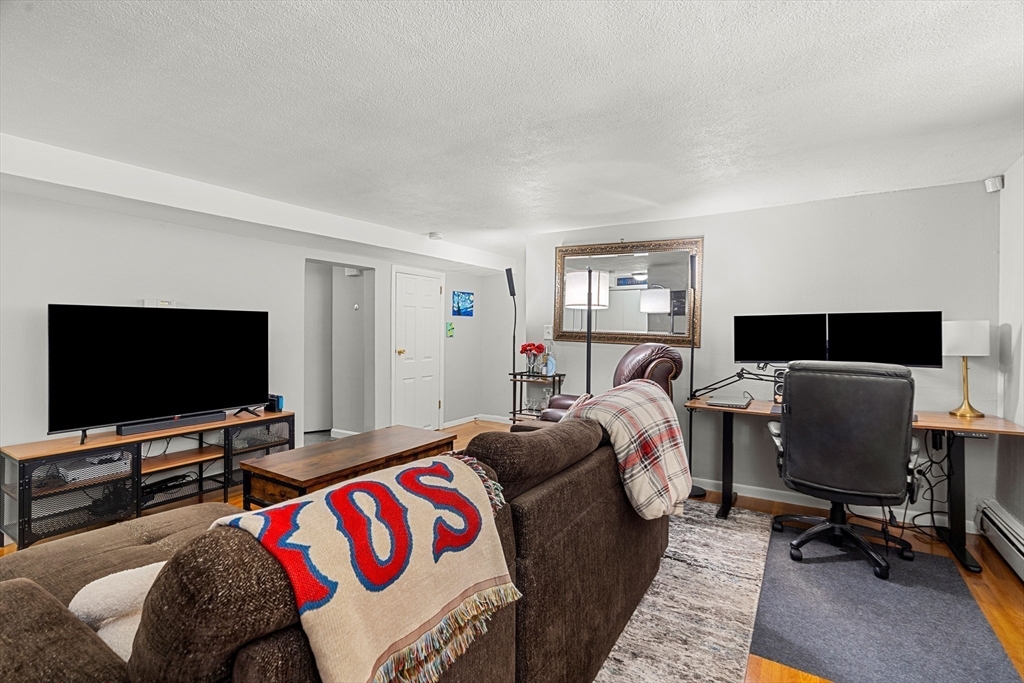 24 Westgate Road, Unit 2 Boston, MA 02467 - Photo 5 of 21 a bedroom with a bed and a flat screen tv