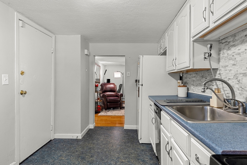 24 Westgate Road, Unit 2 Boston, MA 02467 - Photo 9 of 21 a kitchen that has a sink and a stove
