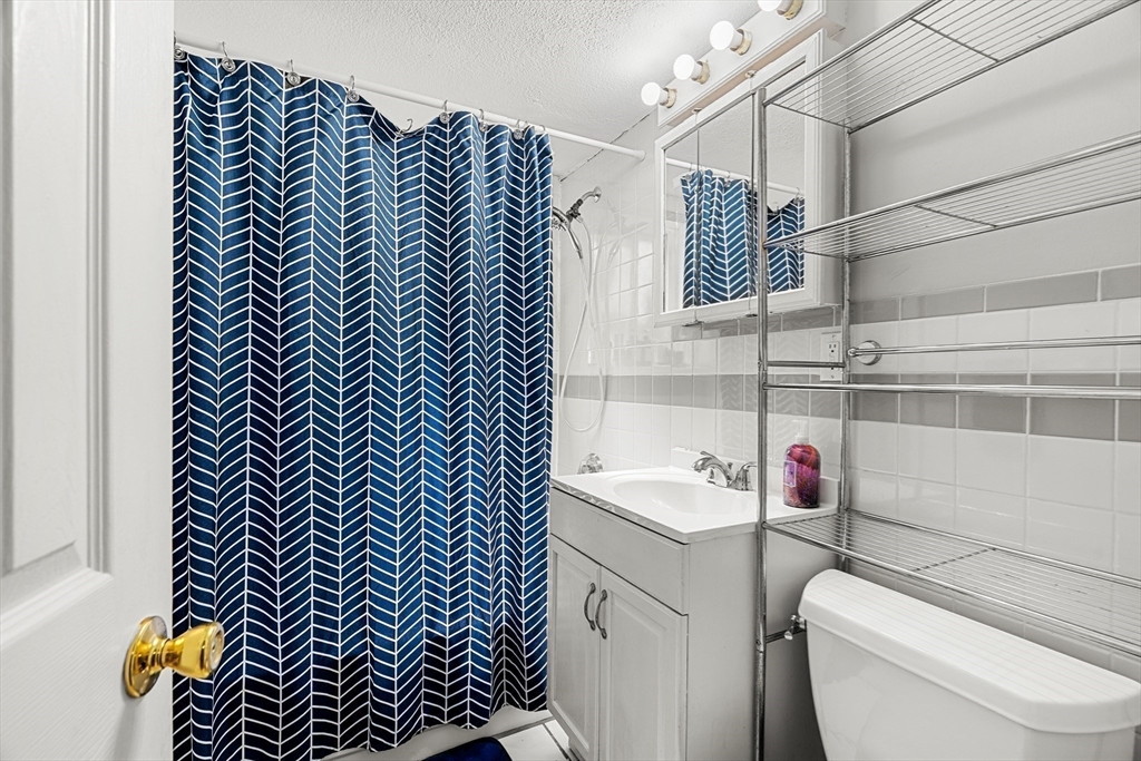 24 Westgate Road, Unit 2 Boston, MA 02467 - Photo 10 of 21 a bathroom with a sink and a shower