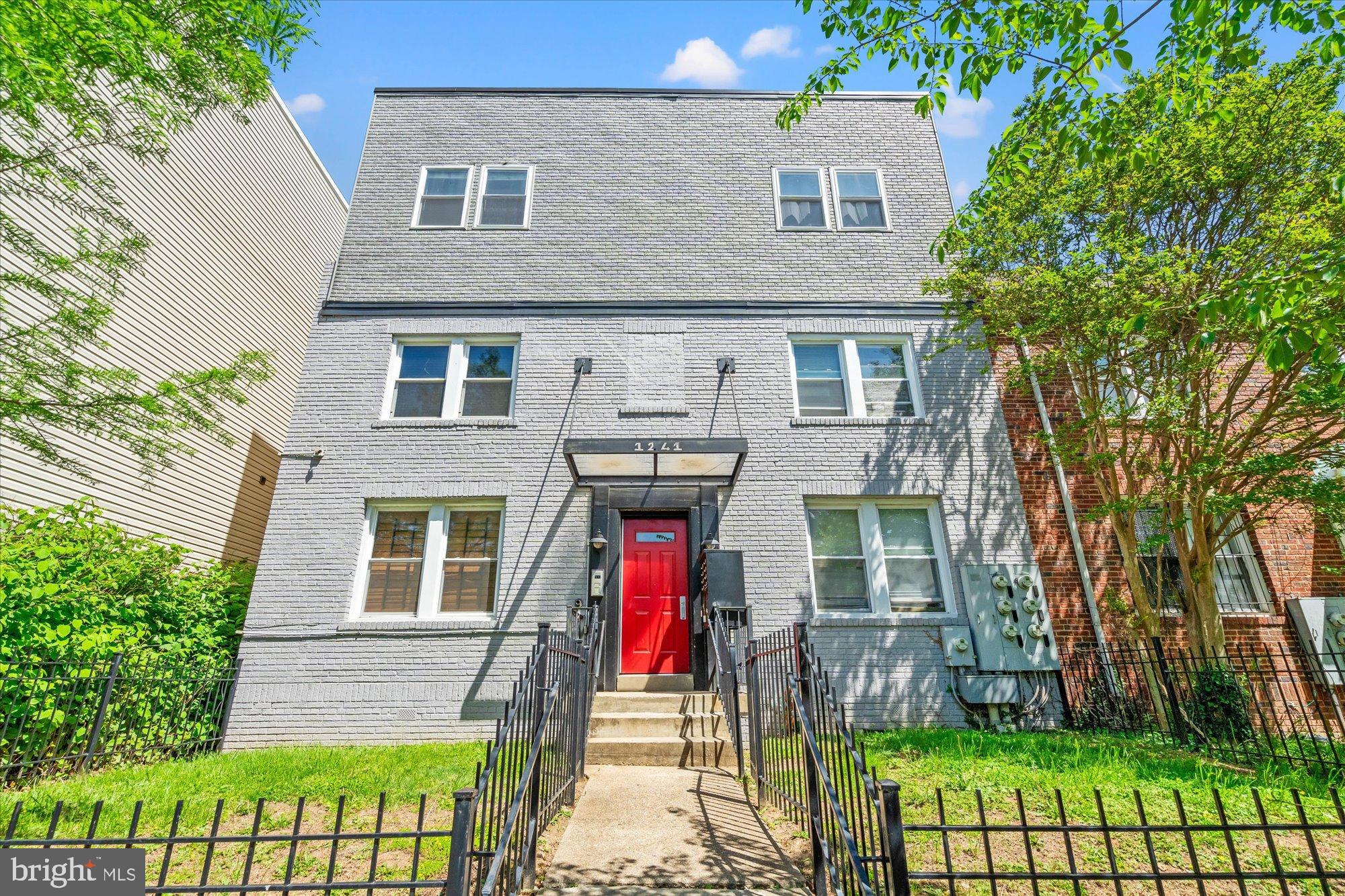 1241 18th Street Northeast, Unit 3 Washington, DC 20002 - Photo 1 of 20 a front view of a house with a yard