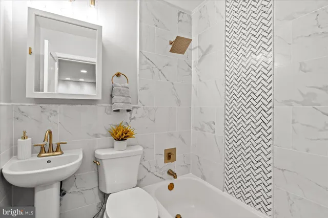 a bathroom with a sink toilet and a mirror