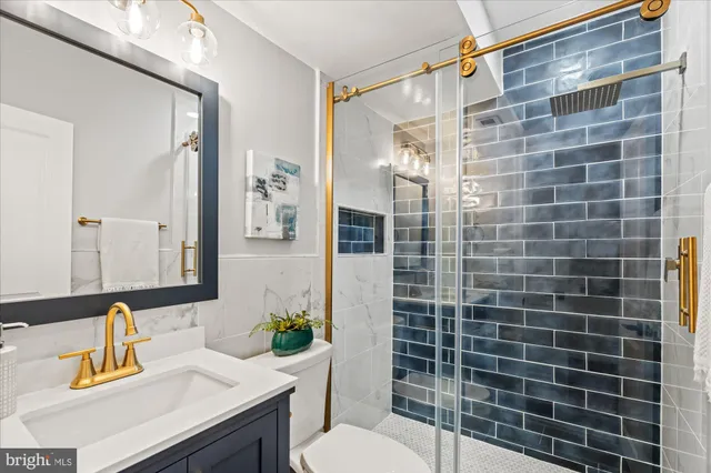 a bathroom with a sink toilet and shower