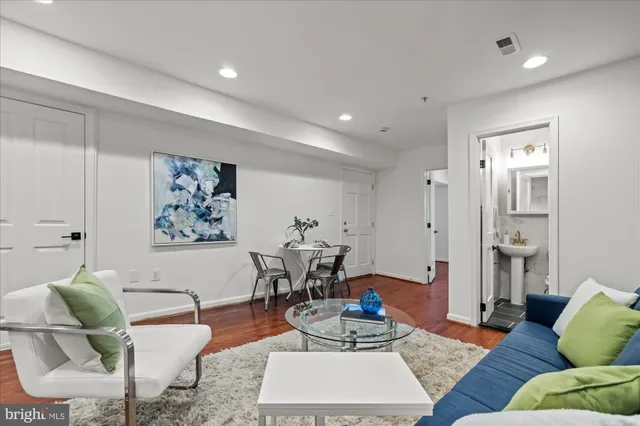 a living room with furniture and a wooden floor