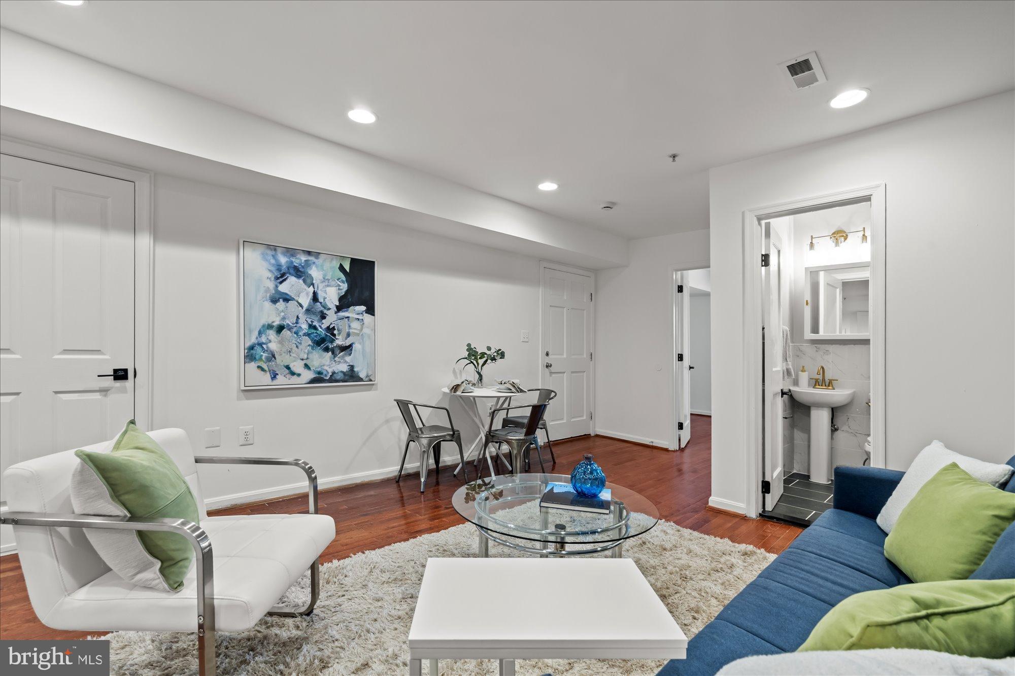 1241 18th Street Northeast, Unit 3 Washington, DC 20002 - Photo 6 of 20 a living room with furniture and a wooden floor