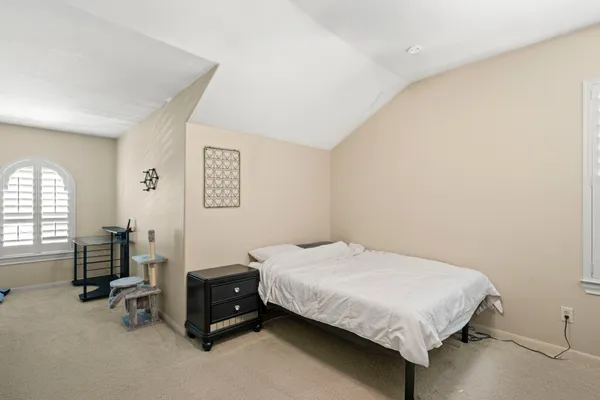 a bedroom with a bed and a table in it