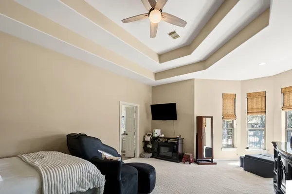 a bedroom with furniture and a flat screen tv
