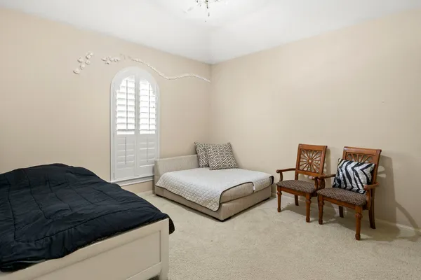 a spacious bedroom with two beds and a window