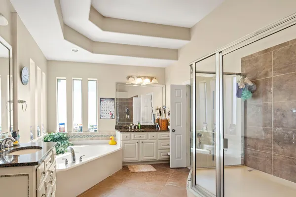 a spacious bathroom with a tub shower and sink