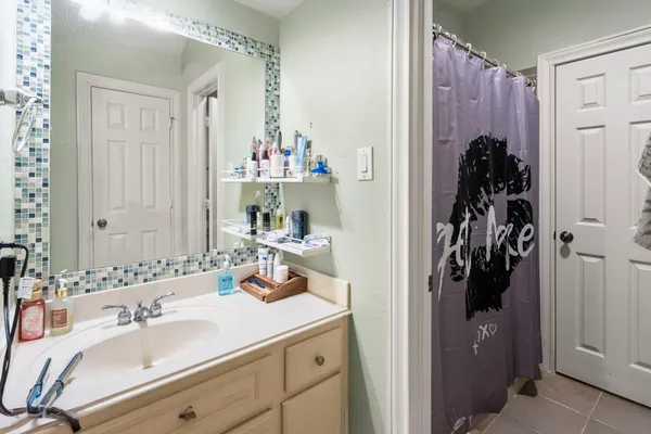 a bathroom with a sink and mirror