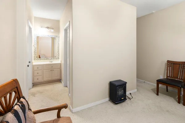 a view of a hallway with entryway and hall with wooden floor