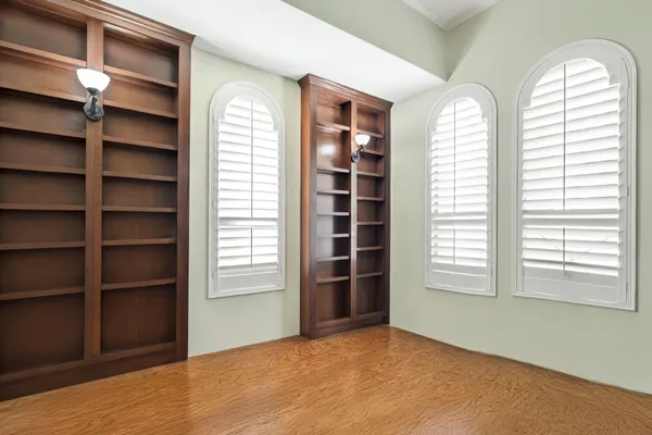 a view of a workspace with furniture and a window