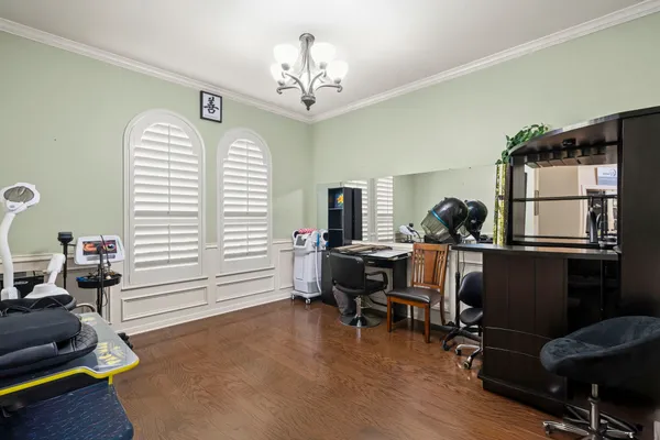 a view of a workspace with furniture and wooden floor
