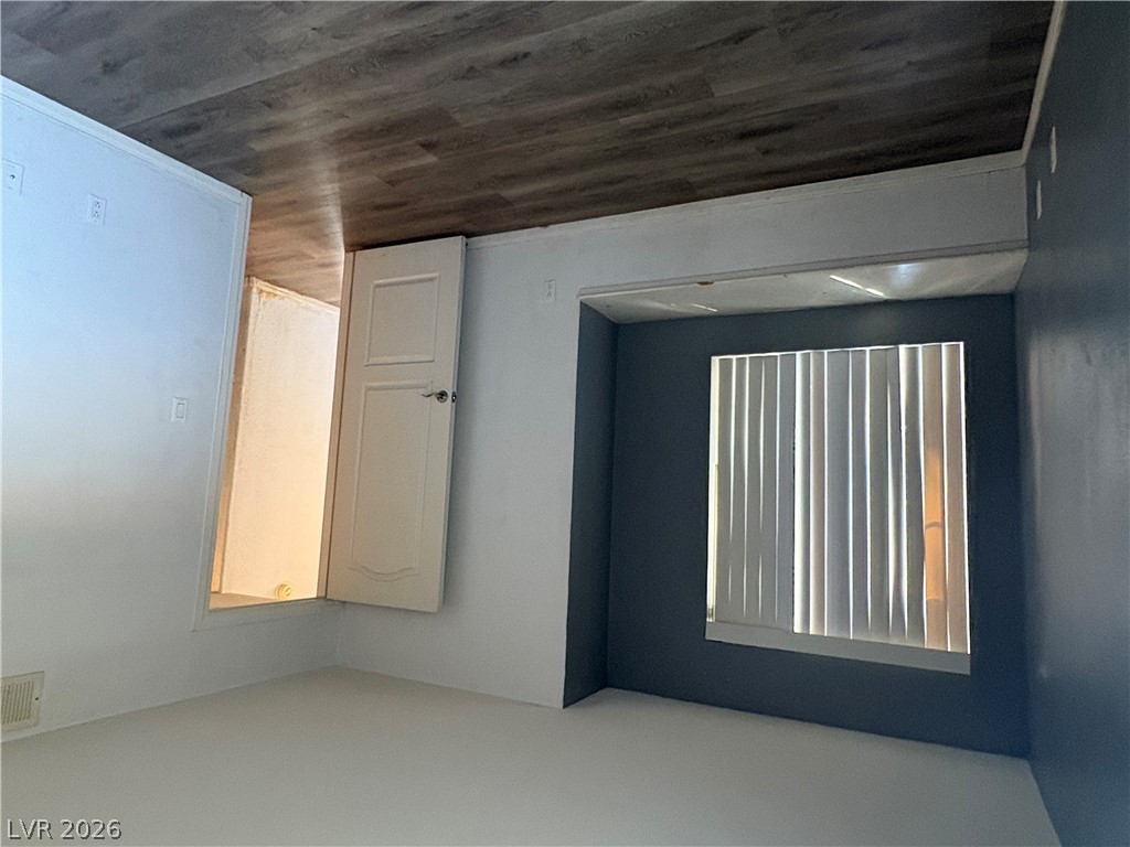 9325 West Desert Inn Road, Unit 123 Las Vegas, NV 89117 - Photo 13 of 36 An inviting room awaits personalization with its warm wood-look flooring and sun-drenched window.