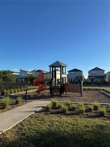 a view of a house with cars parked