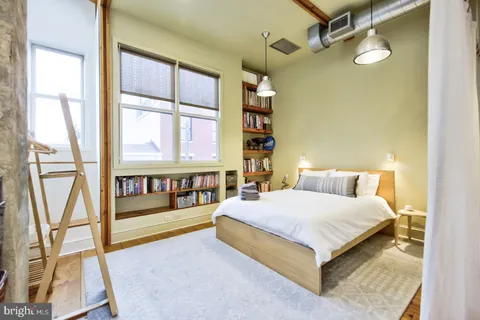 a bedroom with a bed and a window