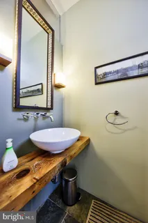 a bathroom with a sink mirror and toilet