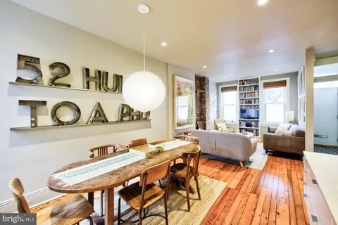 a living room with a couch and a wooden floor