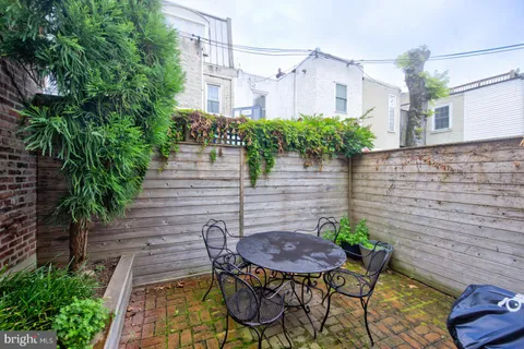 a view of a chairs and table in backyard