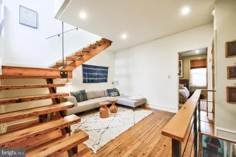 a living room with furniture and wooden floor