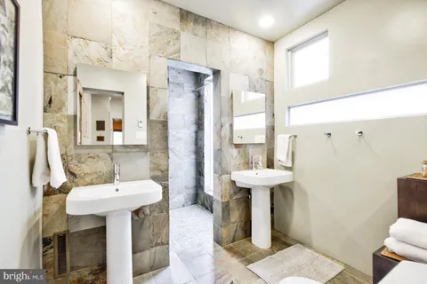 a bathroom with a sink toilet and a mirror