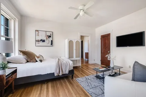 a bedroom with a bed and a flat screen tv