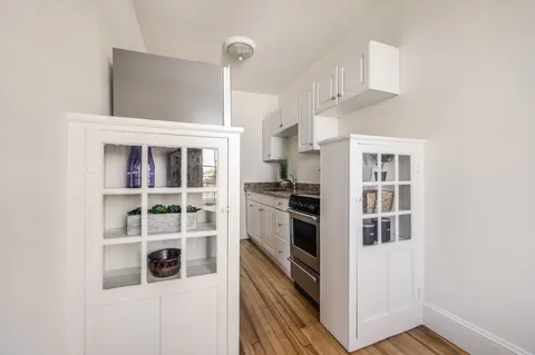 a kitchen with cabinets and window