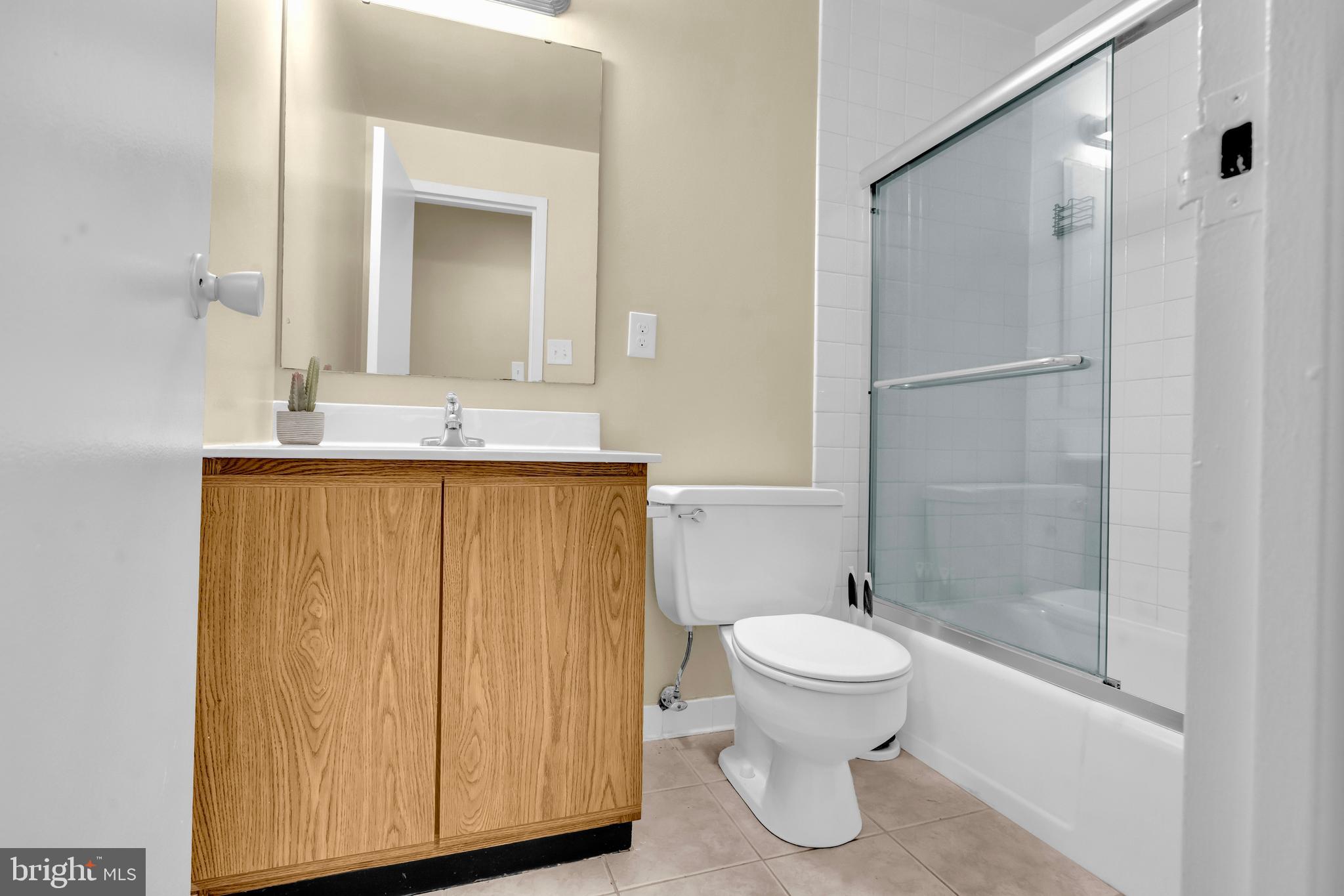 9920 Walker House Road, Unit 5 Gaithersburg, MD 20886 - Photo 14 of 24 a bathroom with a granite countertop sink toilet and shower