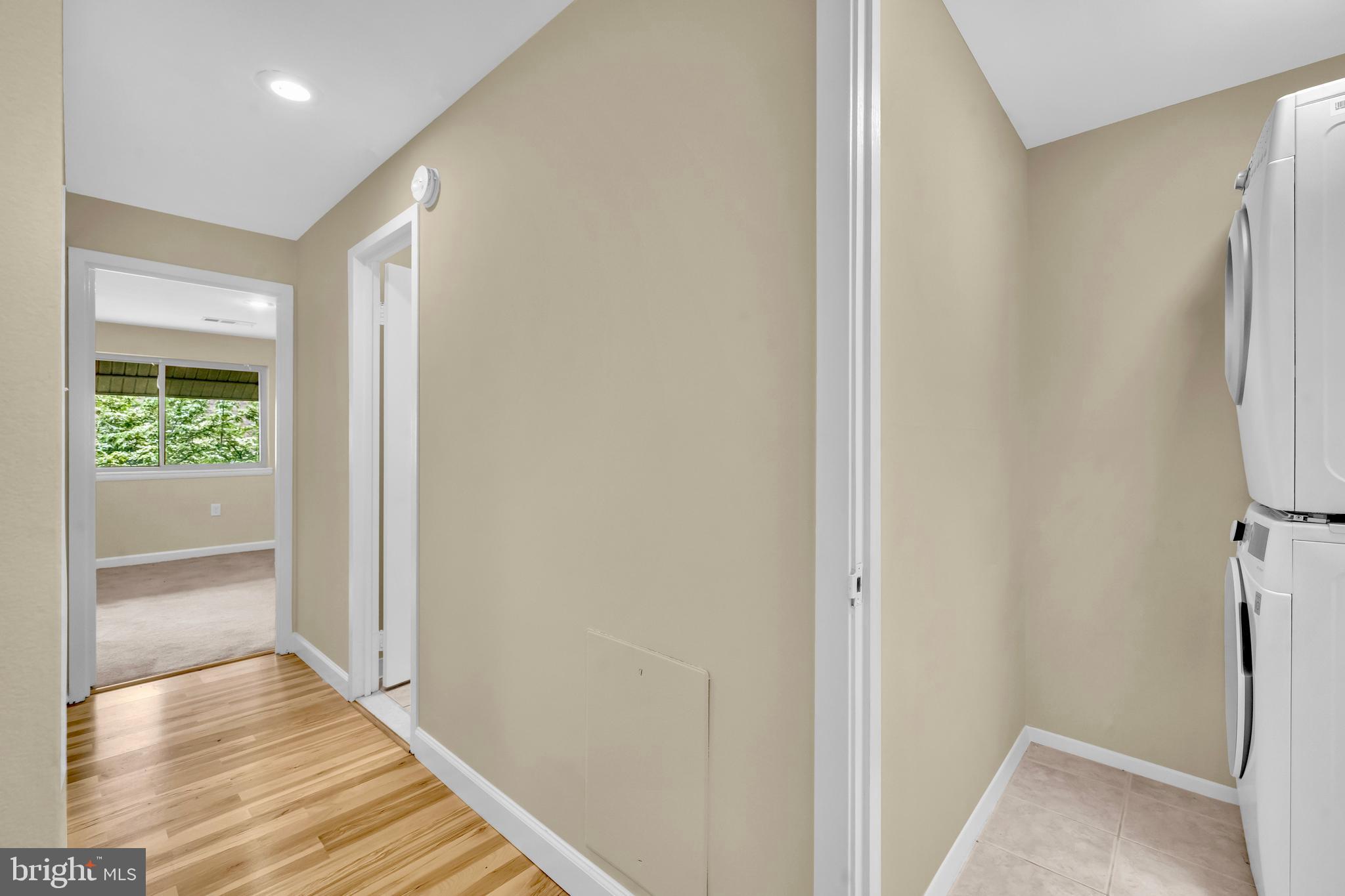 9920 Walker House Road, Unit 5 Gaithersburg, MD 20886 - Photo 19 of 24 a view of a hallway with wooden floor and a bathroom