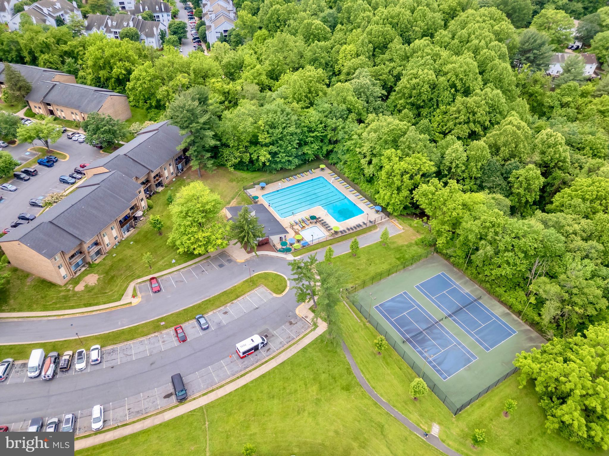 9920 Walker House Road, Unit 5 Gaithersburg, MD 20886 - Photo 21 of 24 an aerial view of a tennis ground and large trees