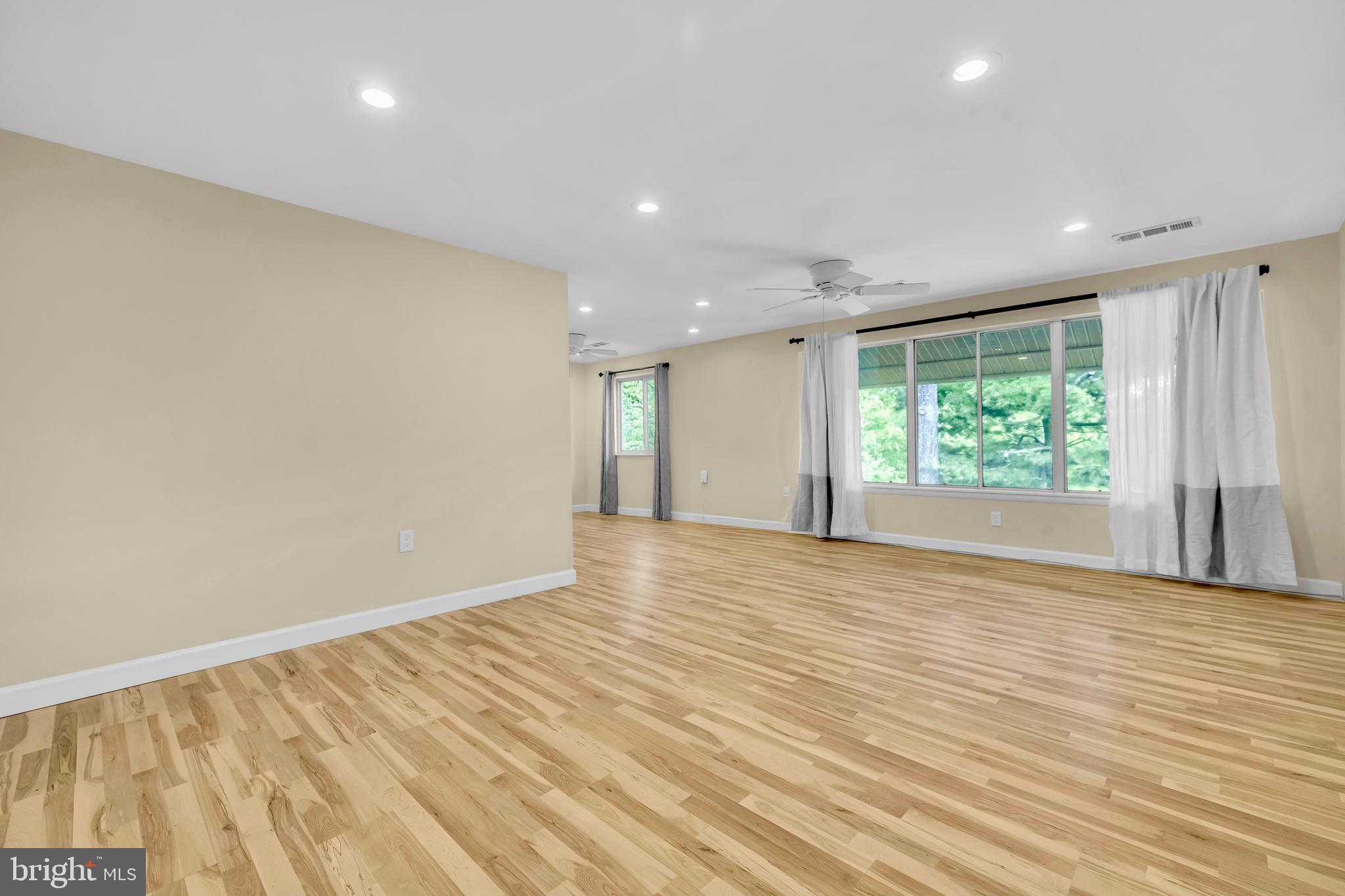 9920 Walker House Road, Unit 5 Gaithersburg, MD 20886 - Photo 3 of 24 an empty room with wooden floor and windows