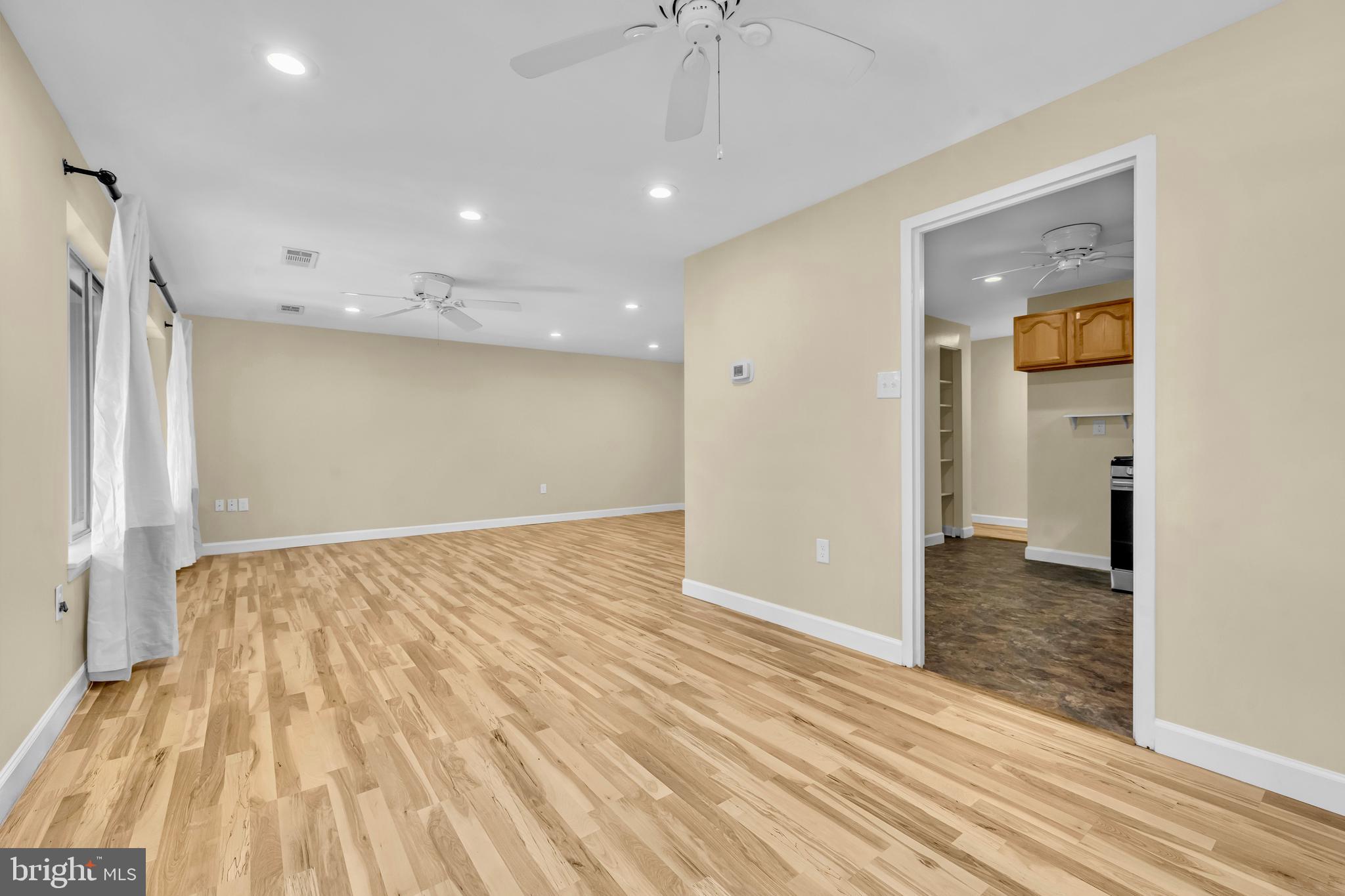 9920 Walker House Road, Unit 5 Gaithersburg, MD 20886 - Photo 5 of 24 wooden floor in an empty room with a window