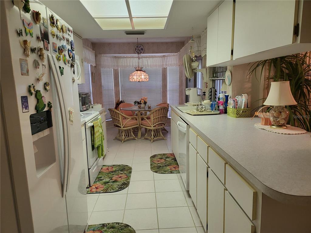 2687 Royal Ridge Drive Spring Hill, FL 34606 - Photo 7 of 15 a kitchen with stainless steel appliances granite countertop a sink and a refrigerator