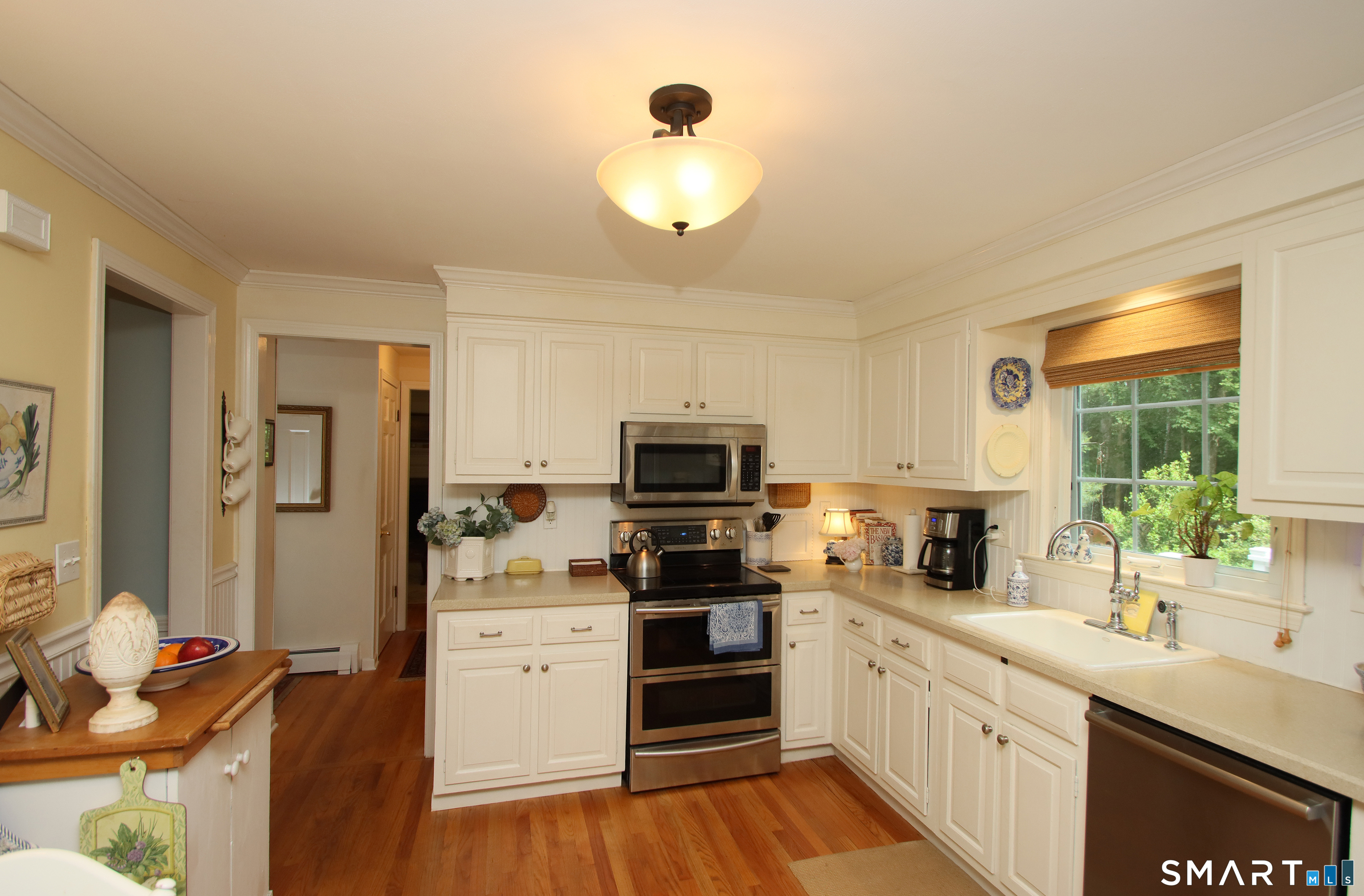 49 Hammonassett Meadows Road Madison, CT 06443 - Photo 5 of 31 Stainless steel appliances and white cabinets