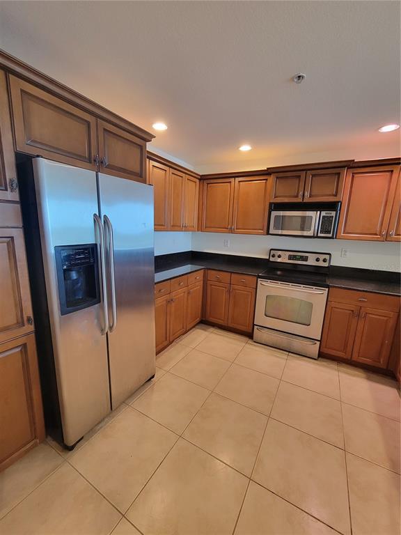 1771 Ringling Boulevard, Unit 902 Sarasota, FL 34236 - Photo 14 of 60 a kitchen with stainless steel appliances granite countertop a refrigerator and a sink