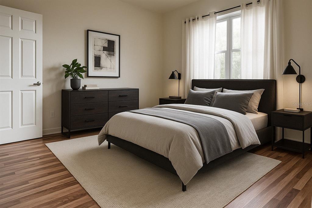 1771 Ringling Boulevard, Unit 902 Sarasota, FL 34236 - Photo 16 of 60 a bedroom with a bed and wooden floor