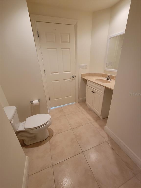 1771 Ringling Boulevard, Unit 902 Sarasota, FL 34236 - Photo 19 of 60 a bathroom with a sink a toilet and a mirror