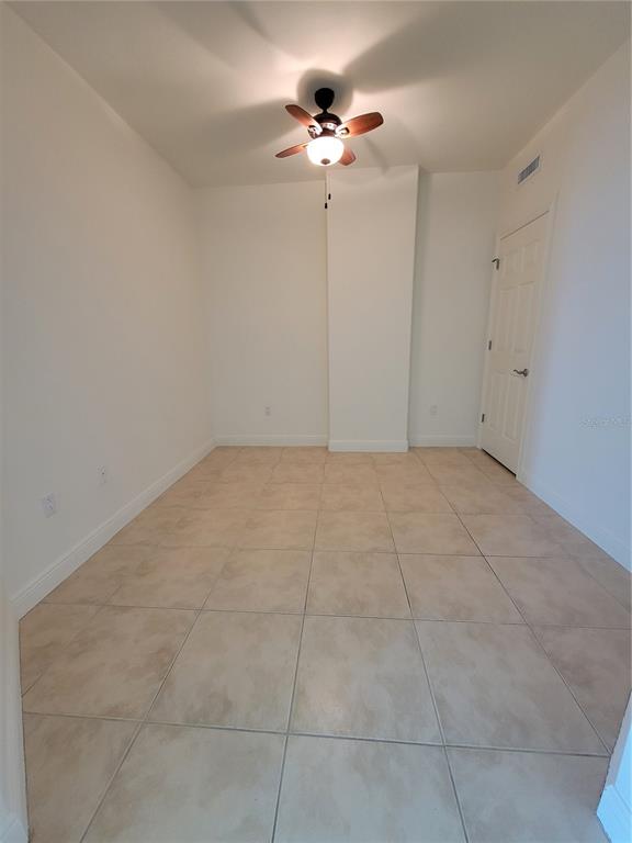 1771 Ringling Boulevard, Unit 902 Sarasota, FL 34236 - Photo 21 of 60 a view of an empty room with a ceiling fan