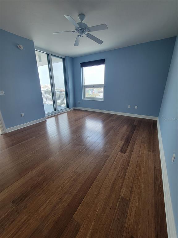 1771 Ringling Boulevard, Unit 902 Sarasota, FL 34236 - Photo 29 of 60 an empty room with wooden floor and windows