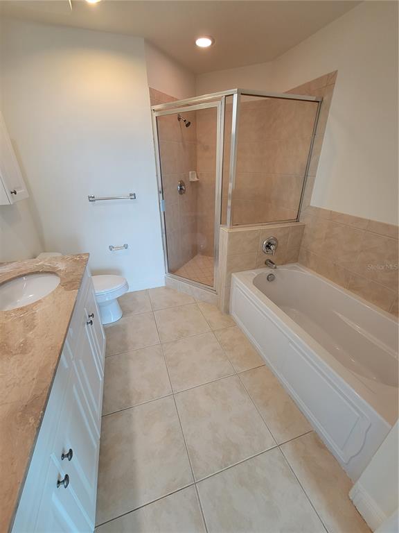 1771 Ringling Boulevard, Unit 902 Sarasota, FL 34236 - Photo 37 of 60 a spacious bathroom with a granite countertop sink a toilet and shower